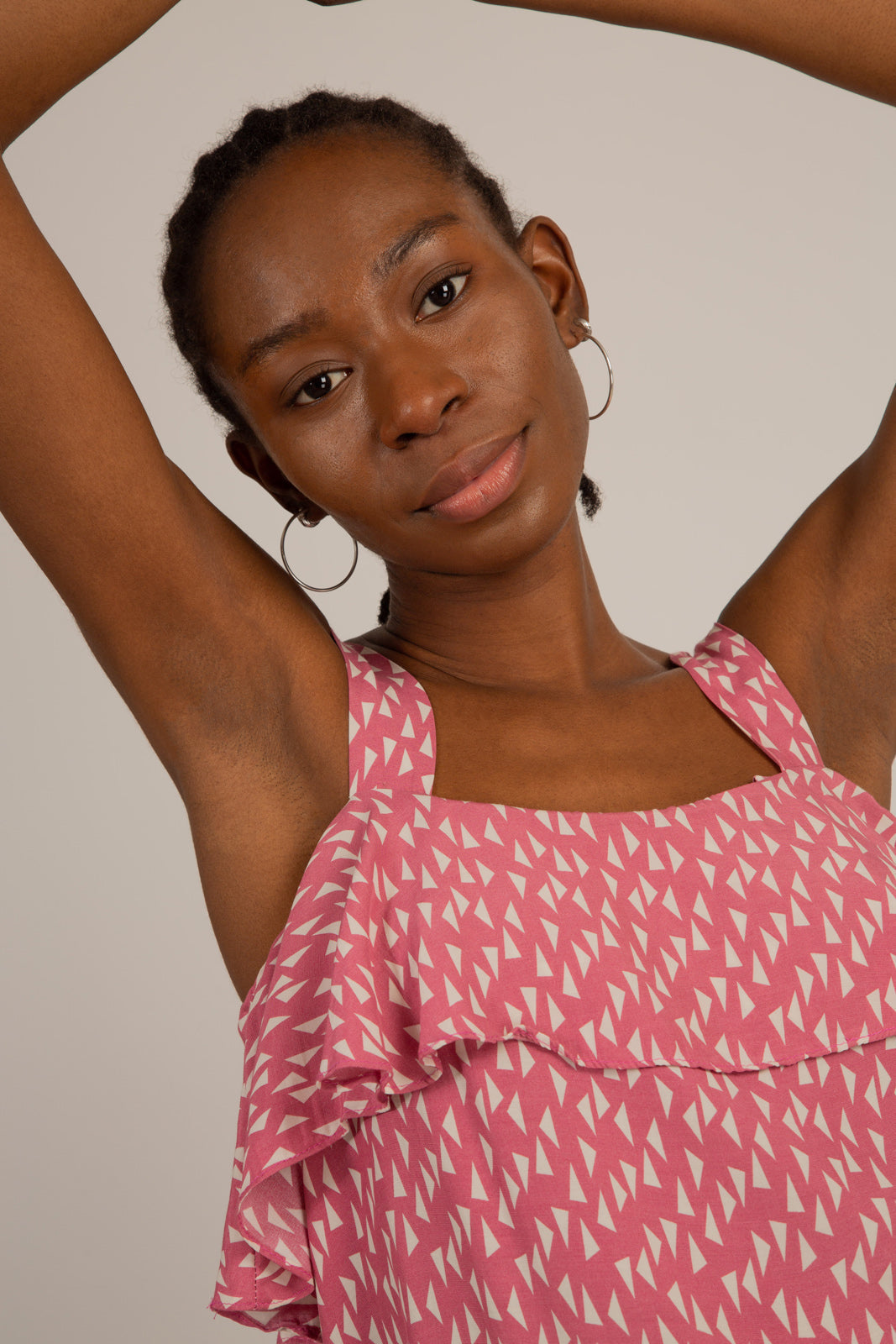 Pink and white triangle print ruffle tank