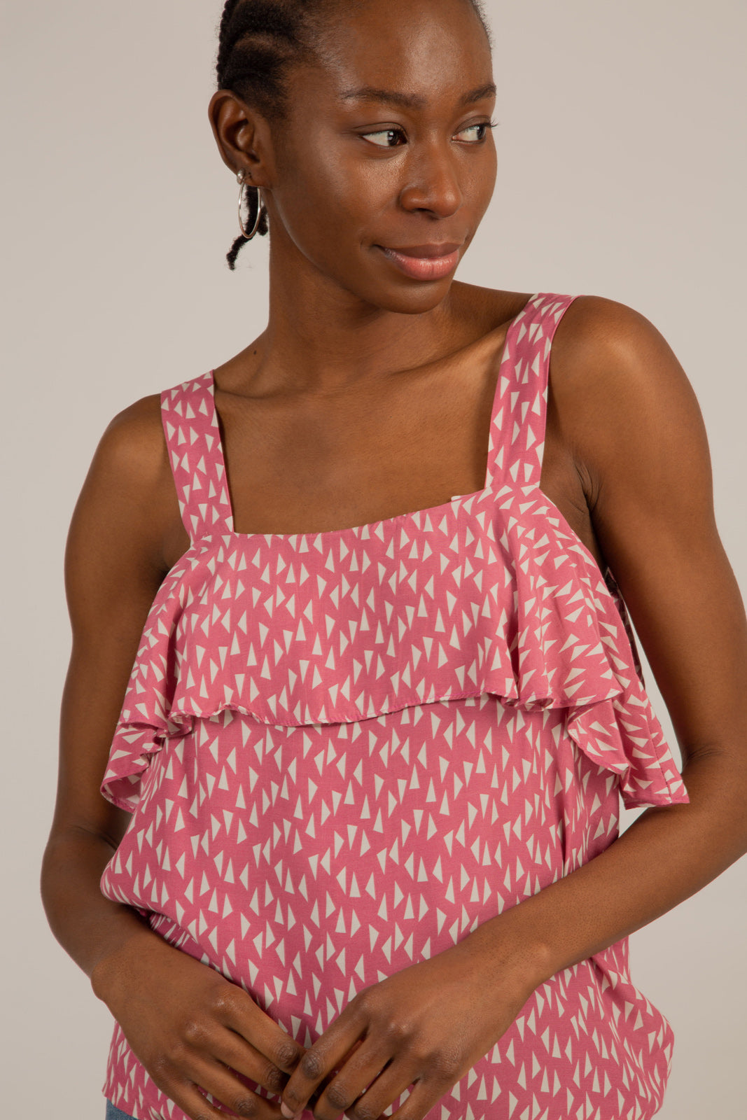 Pink and white triangle print ruffle tank