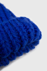 Cobalt blue ribbed black feather pom pom hat