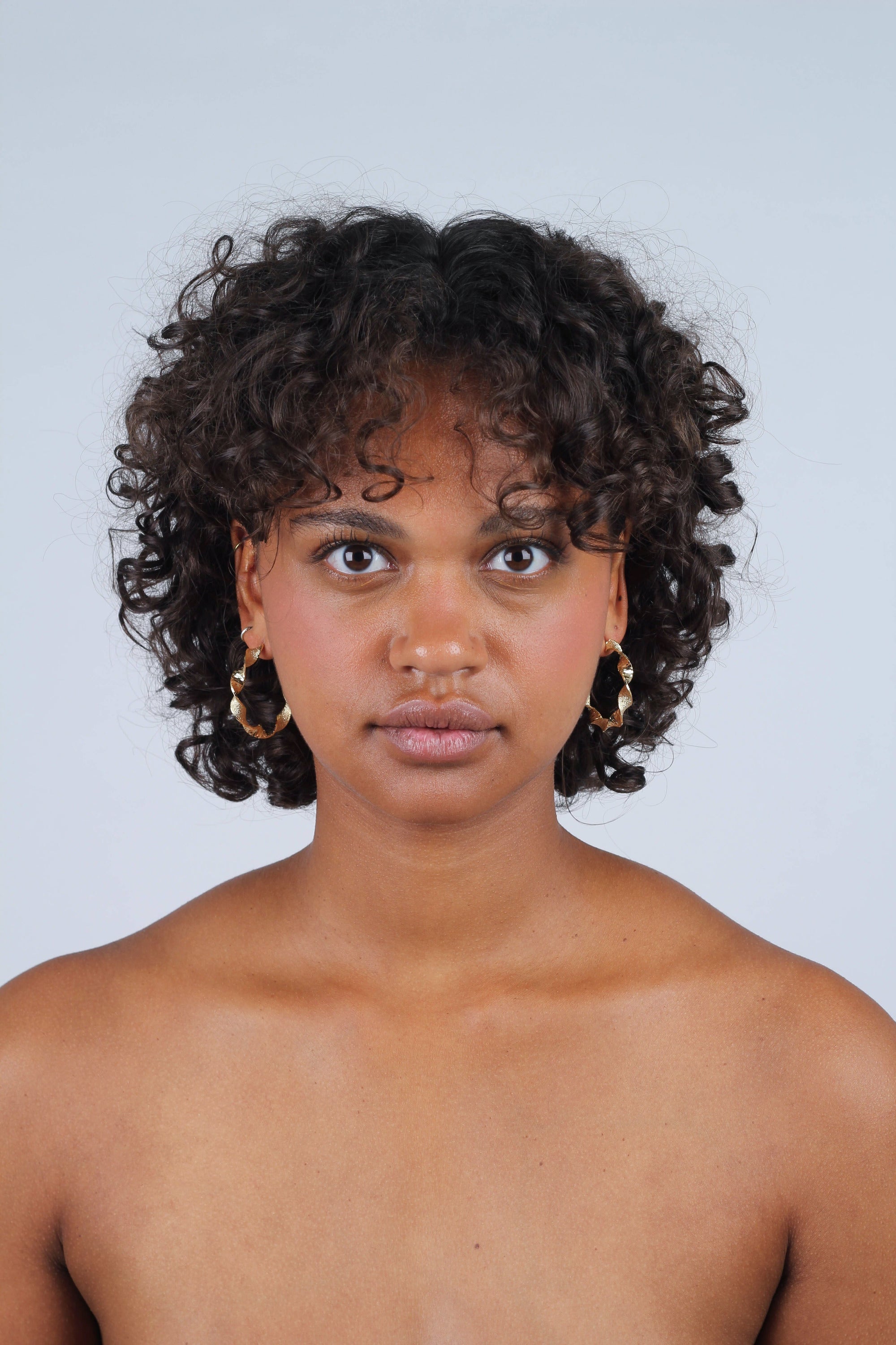 Gold rough smooth twisted hoop earrings