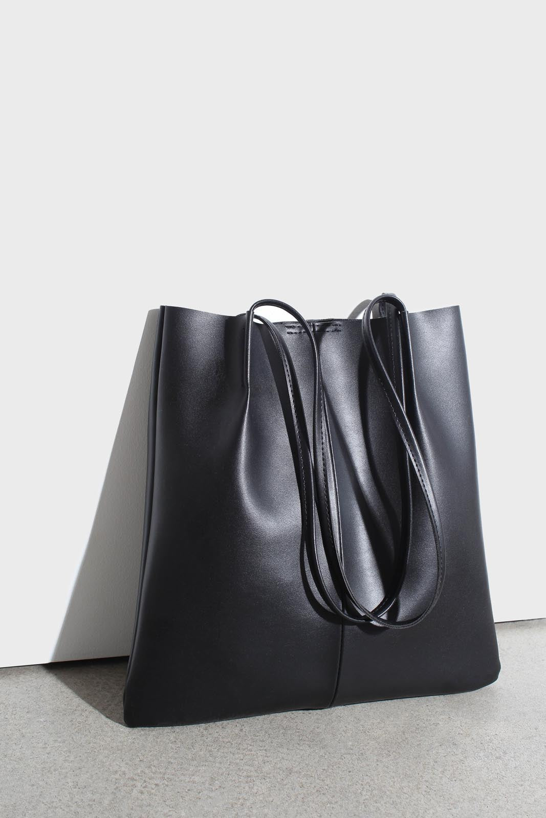 Black vegan leather pinched strap tote bag