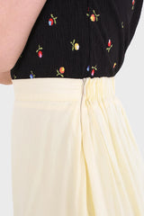 Pale yellow asymmetric hem midi skirt