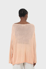 Pale orange wide neck long sleeved loose knit top