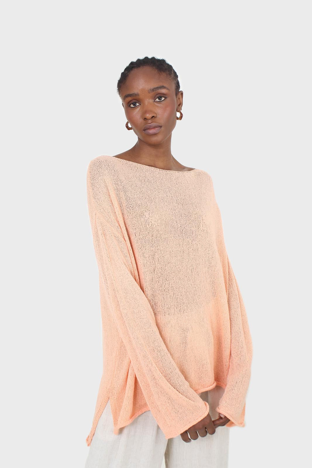 Pale orange wide neck long sleeved loose knit top