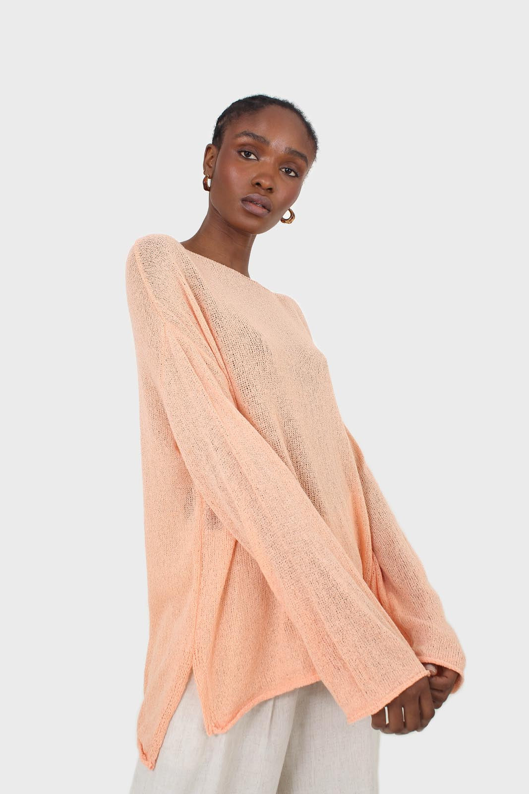 Pale orange wide neck long sleeved loose knit top