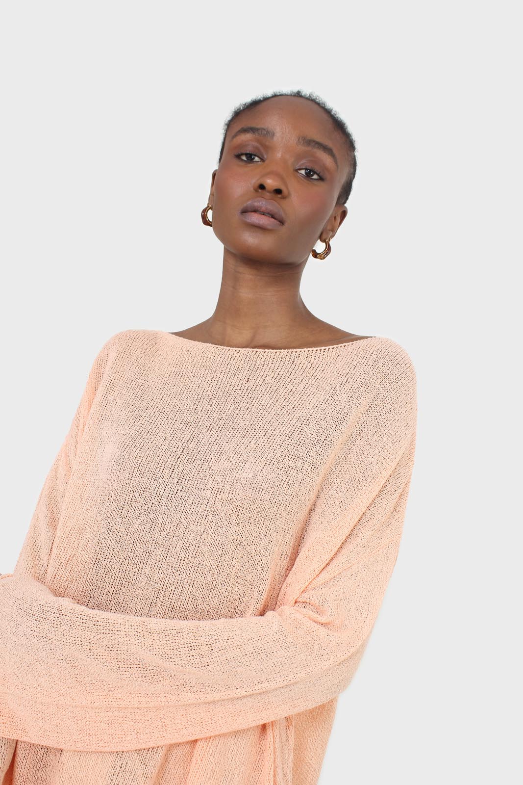 Pale orange wide neck long sleeved loose knit top