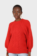Bright red chunky cable knit balloon sleeved jumper