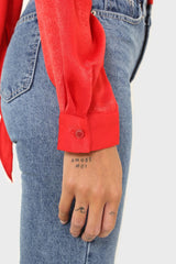 Bright red textured silky plunging tie front shirt