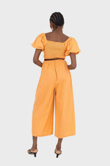 Orange short sleeved ruched bodice jumpsuit