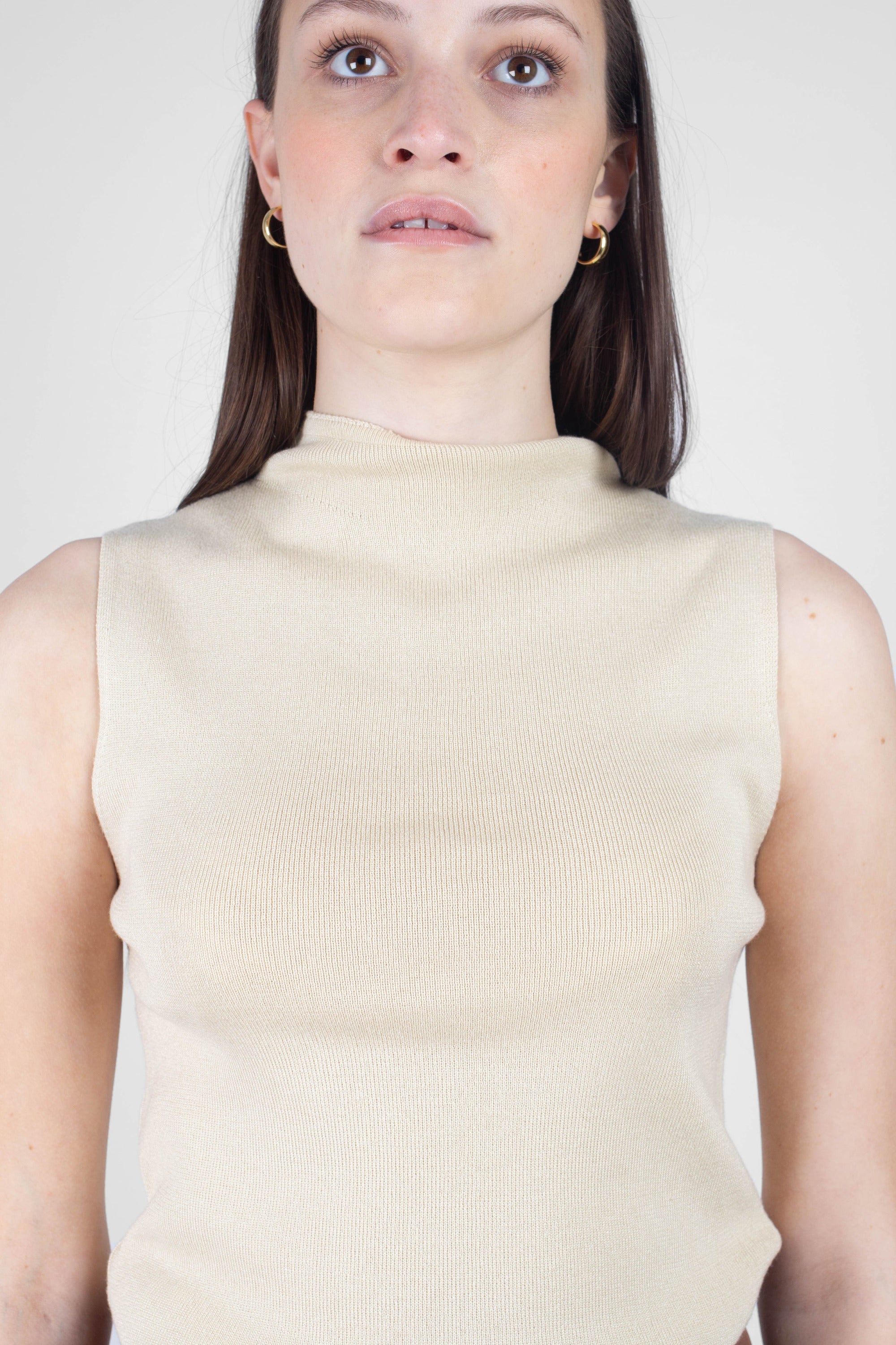 Light beige sleeveless mock neck knit tank