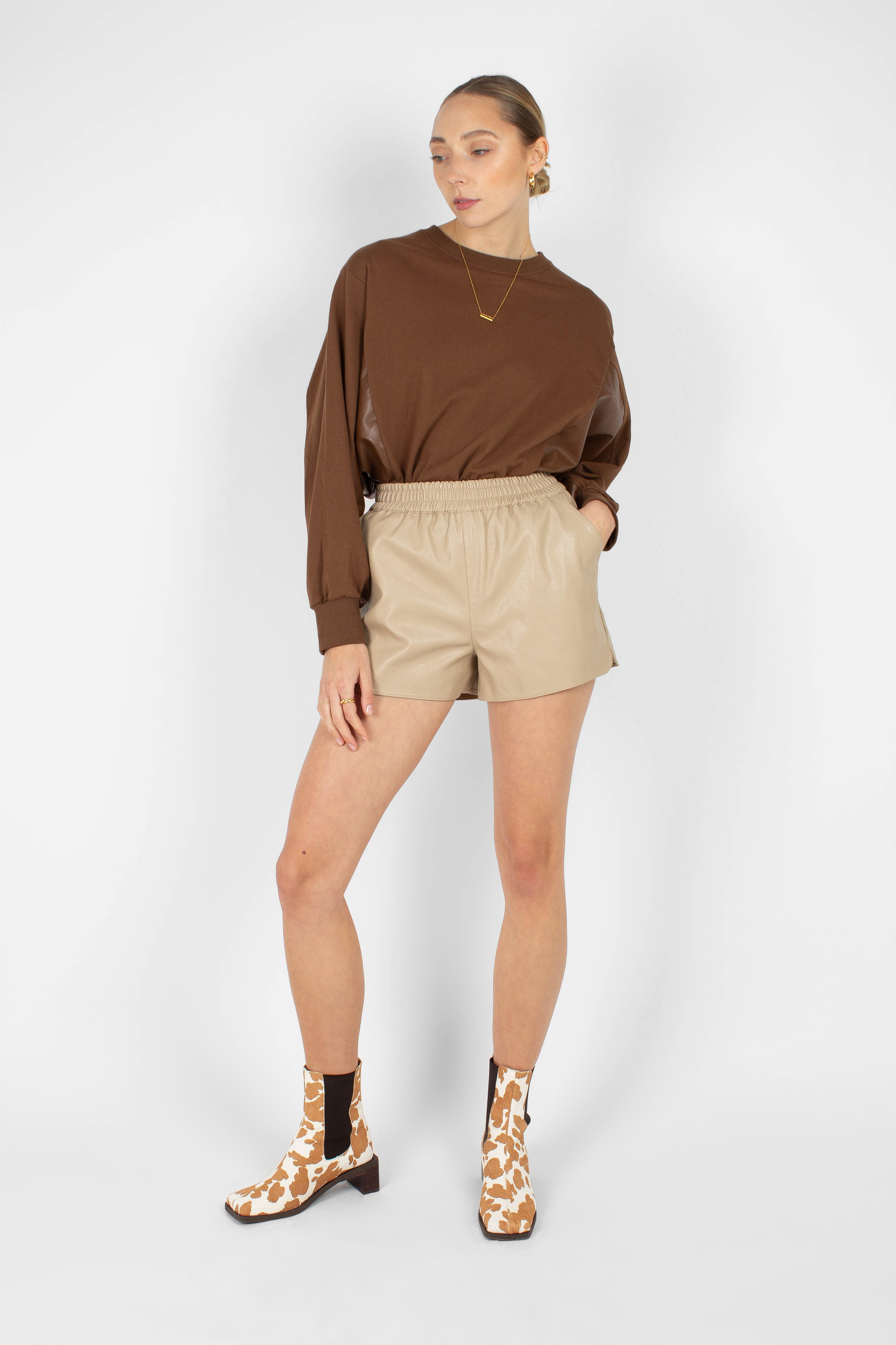 Beige vegan leather running shorts