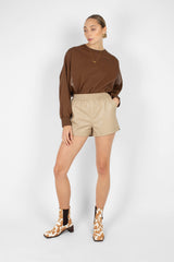 Beige vegan leather running shorts