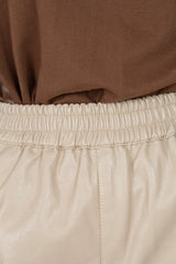 Beige vegan leather running shorts