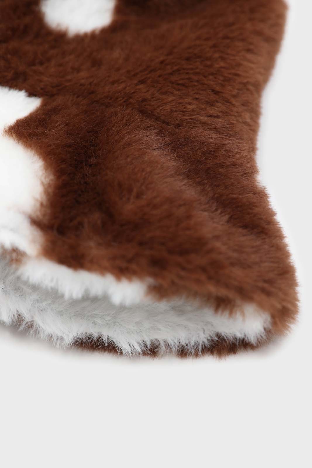 White and brown cow print faux fur bucket hat