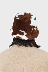 White and brown cow print faux fur bucket hat