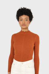 Burnt orange scalloped mock neck knit top
