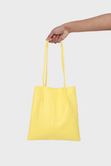 Bright yellow vegan leather pinched strap tote bag