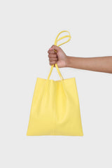 Bright yellow vegan leather pinched strap tote bag