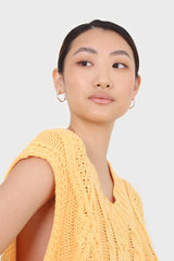 Bright orange cableknit sweater vest