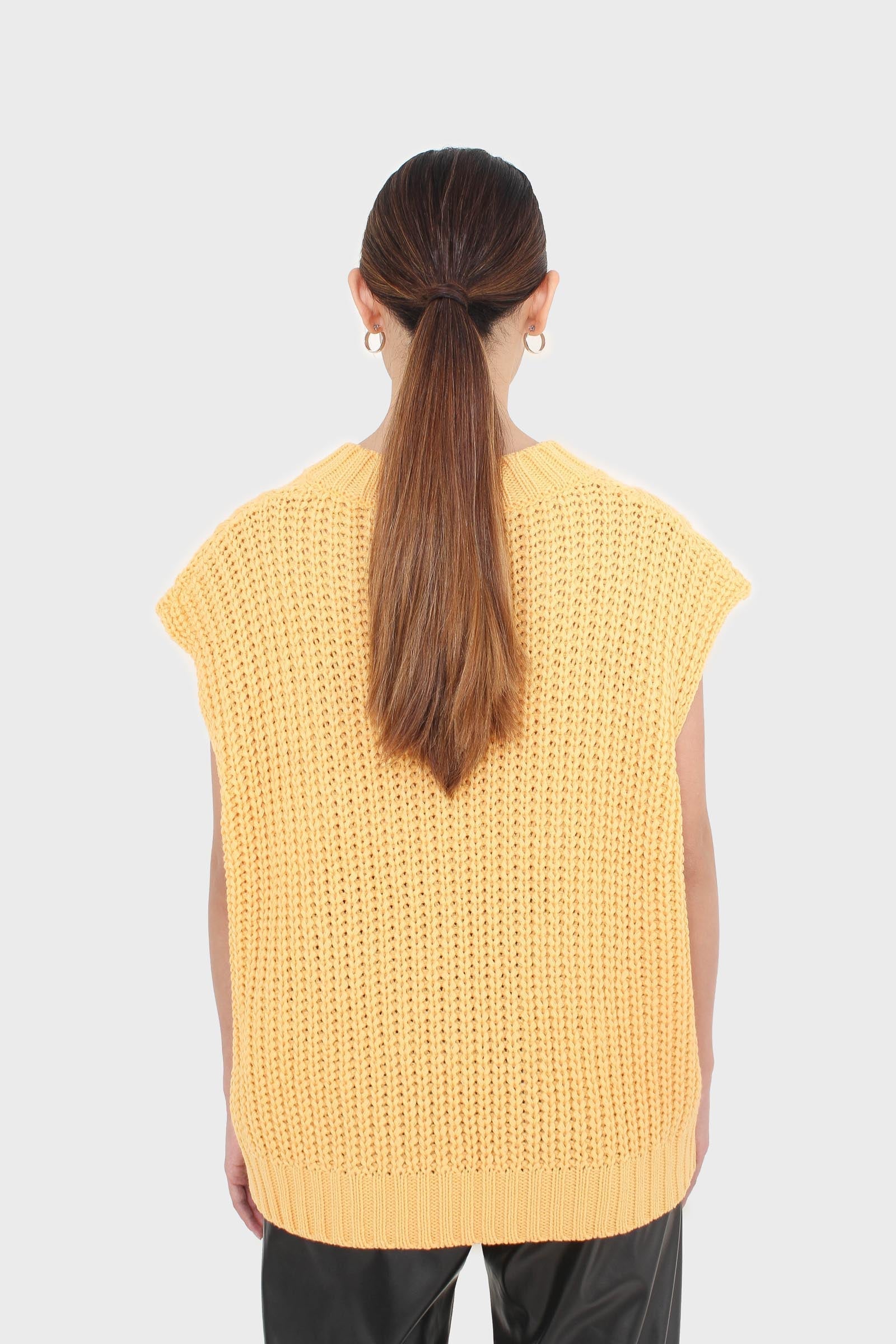Bright orange cableknit sweater vest