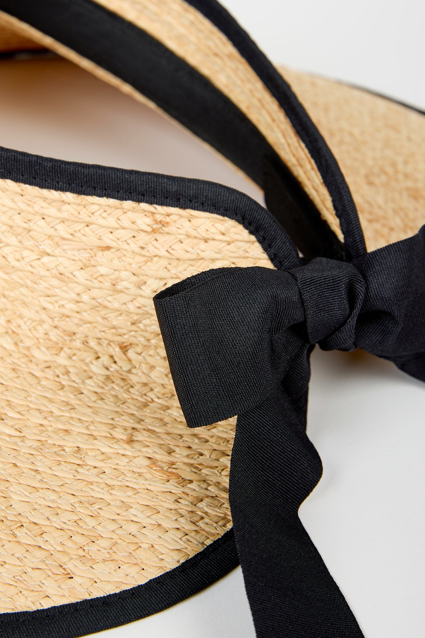 Beige raffia and black trimmed ribbon tie bonnet