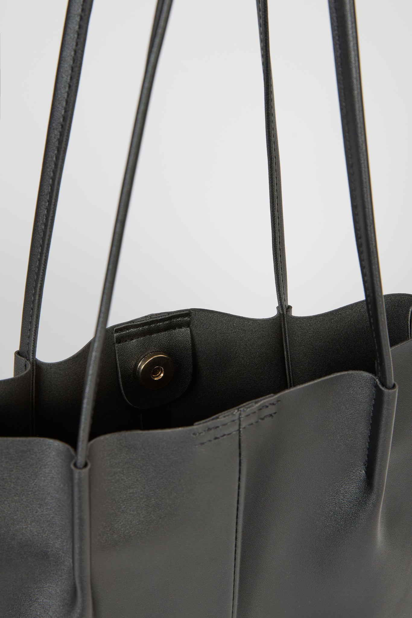 Black vegan leather pinched strap tote bag