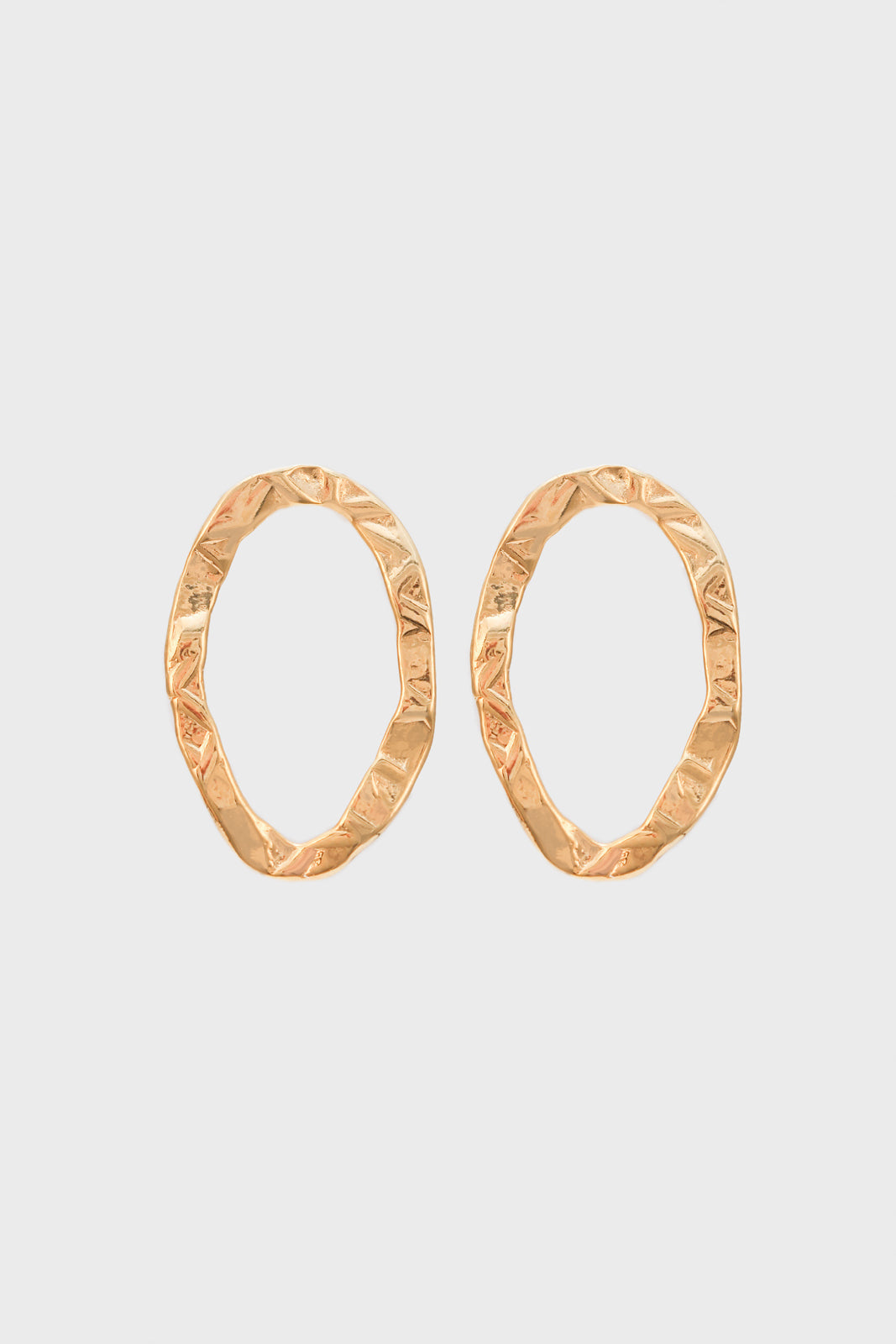 Gold flat hammered oval earrings