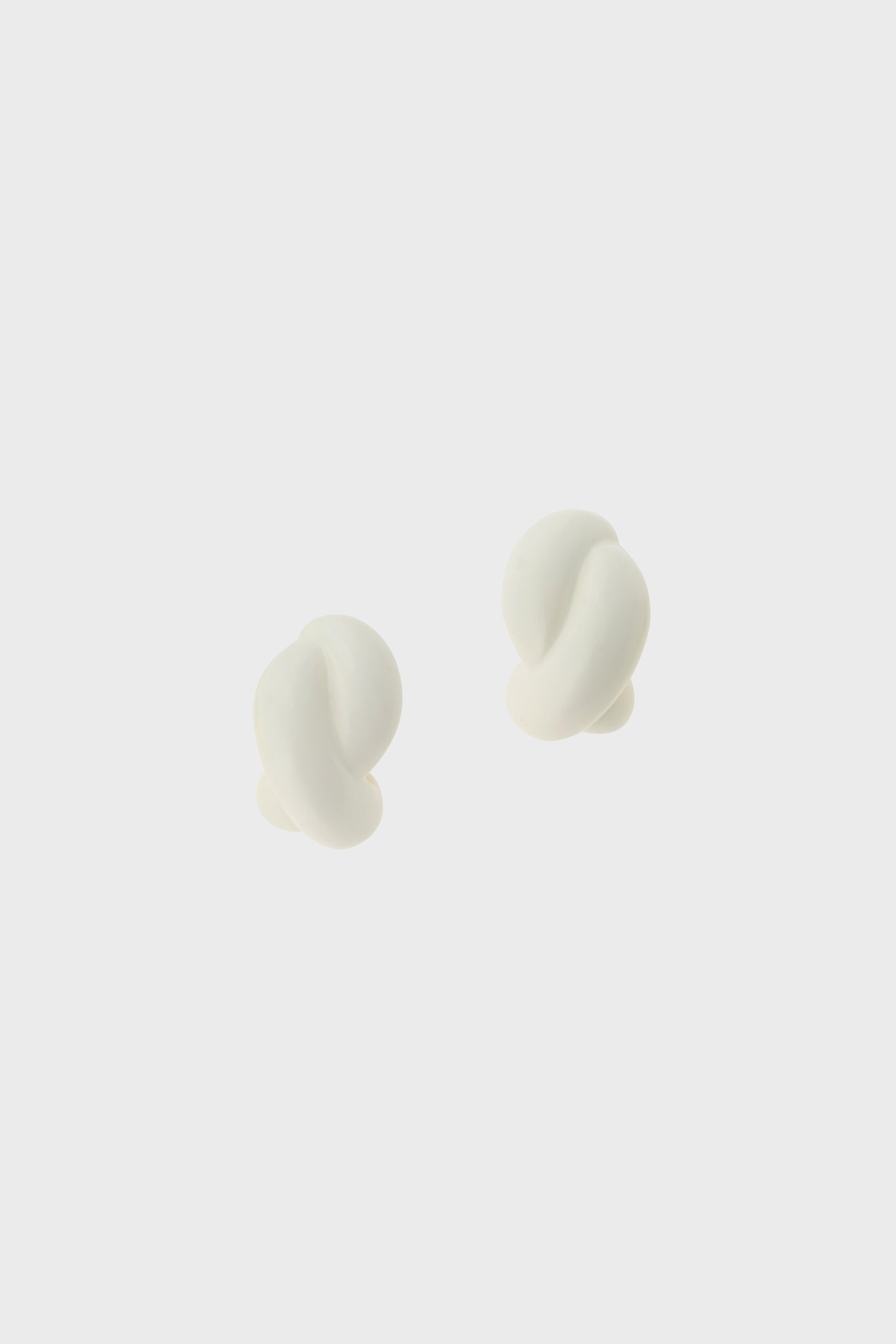 White enamel single twist earrings